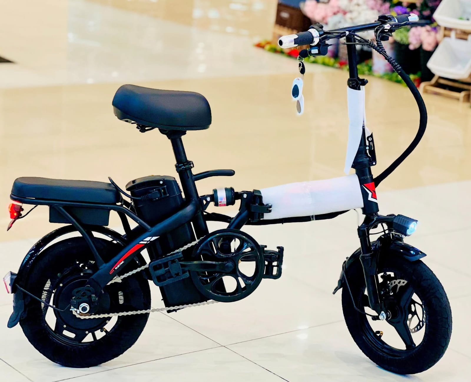 Compact folding electric scooter bike for adults with powerful motor and comfortable design.